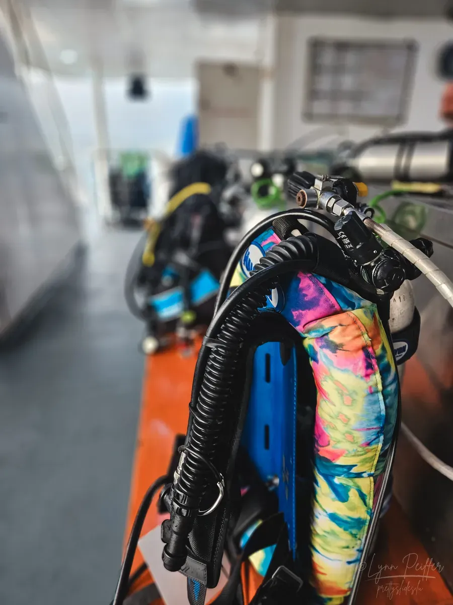 Diving Raja Ampat Indonesia Travel Photos 04 by Lynn Peiffer A colorful BCD on a scuba tank on the White Manta scuba diving liveaboard in Raja Ampat, Indonesia.