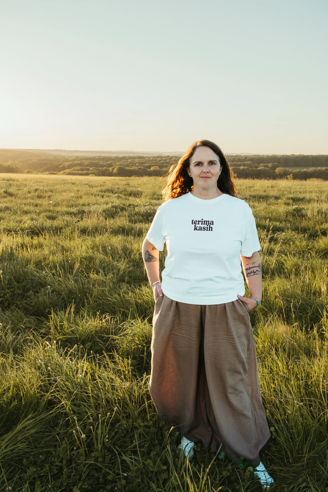 Luxembourg photographer Lynn Peiffer standing on a grassy landscape.