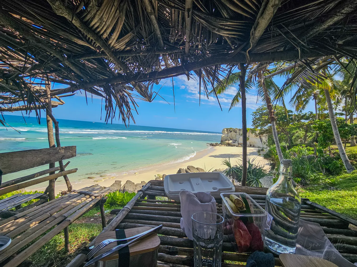 Places of Indonesia Landscape Travel Photos 04 by Lynn Peiffer A picnic lunch in a bamboo hut next to a white sand beach and turquoise sea in Sumba, Indonesia.