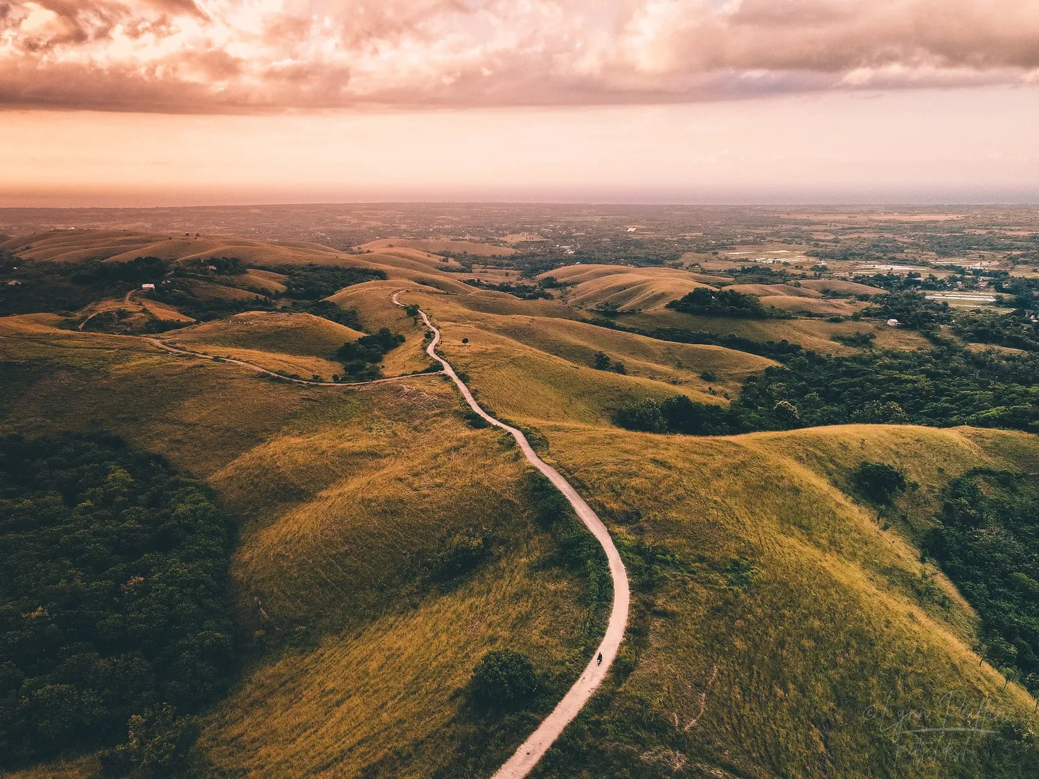 Places of Indonesia Landscape Travel Photos 12 by Lynn Peiffer A road atop rolling green hills in Sumba, Indonesia.