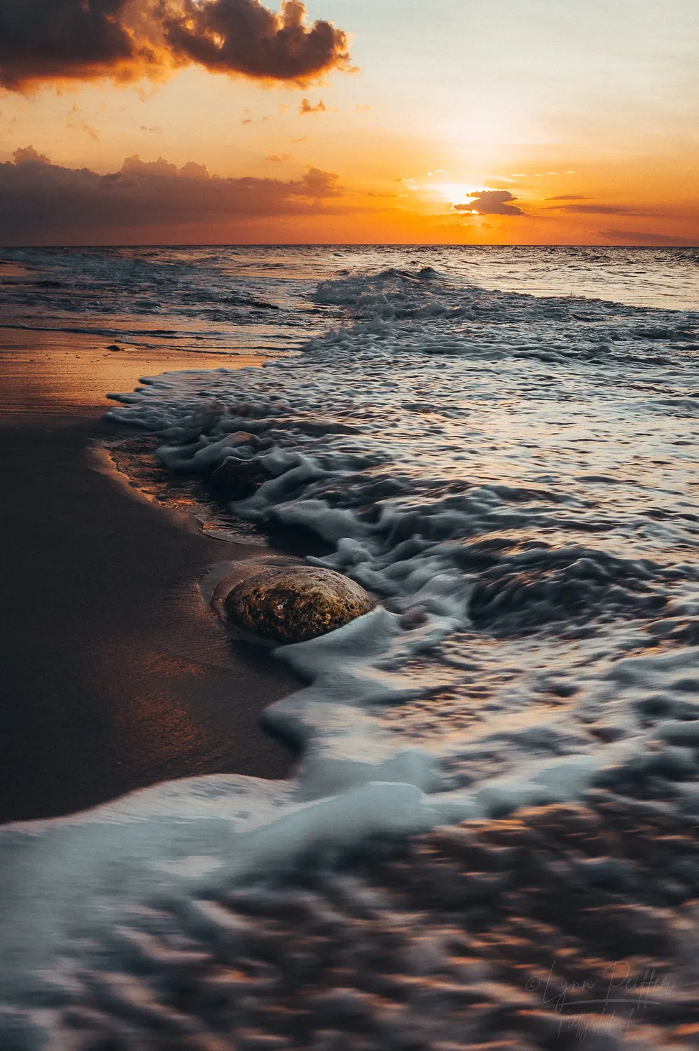 Places of Indonesia Landscape Travel Photos 38 by Lynn Peiffer Waves lap the sand during a striking sunset over the ocean in Sumba, Indonesia.