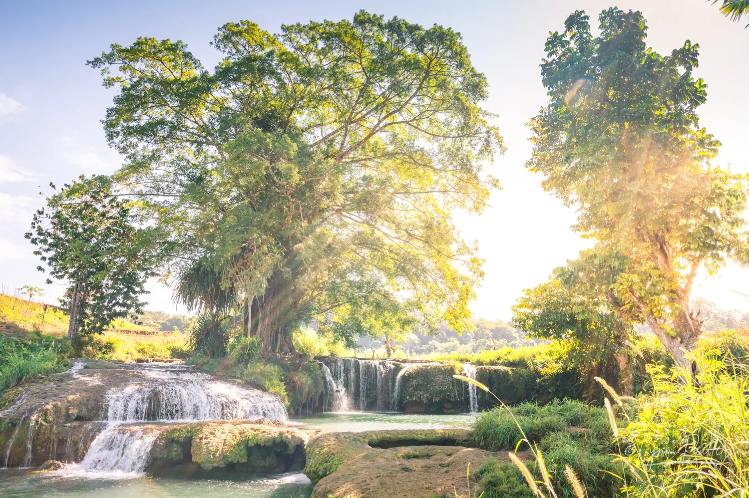 Places of Indonesia Landscape Travel Photos 41 by Lynn Peiffer Water cascades over rocks at a stunning lagoon in Sumba, Indonesia.